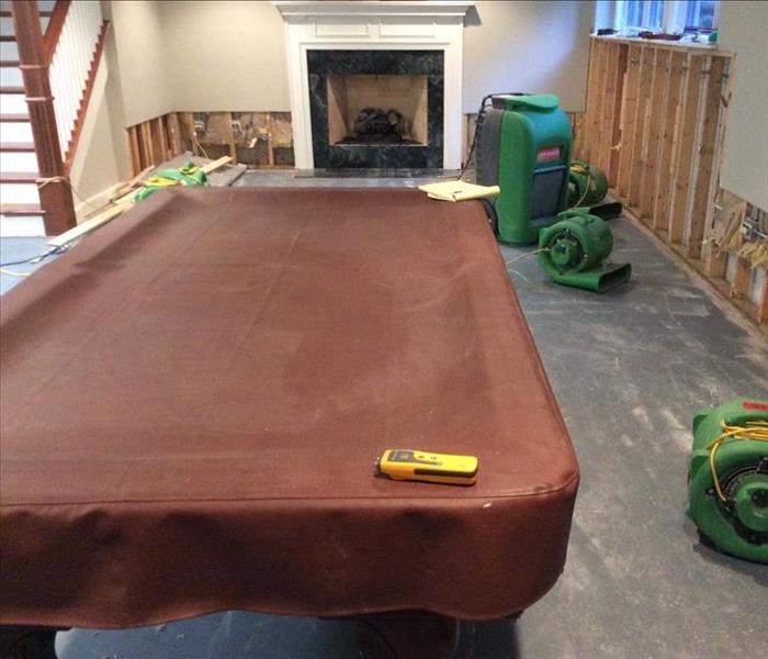 carpet pulled around basement pool table