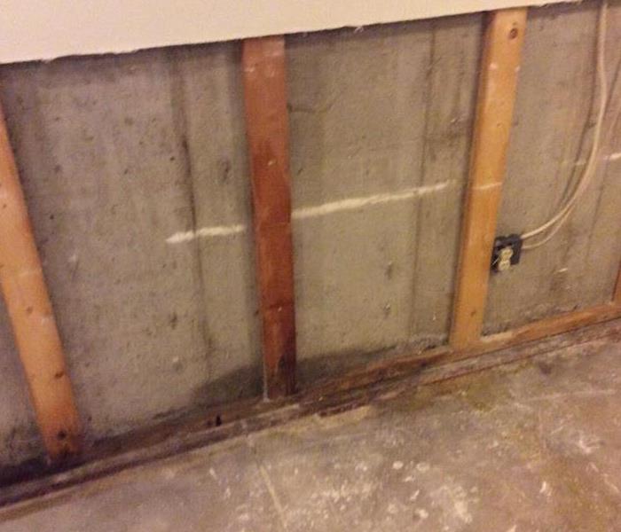 drywall is pulled/ cut away  from the walls exposed concrete