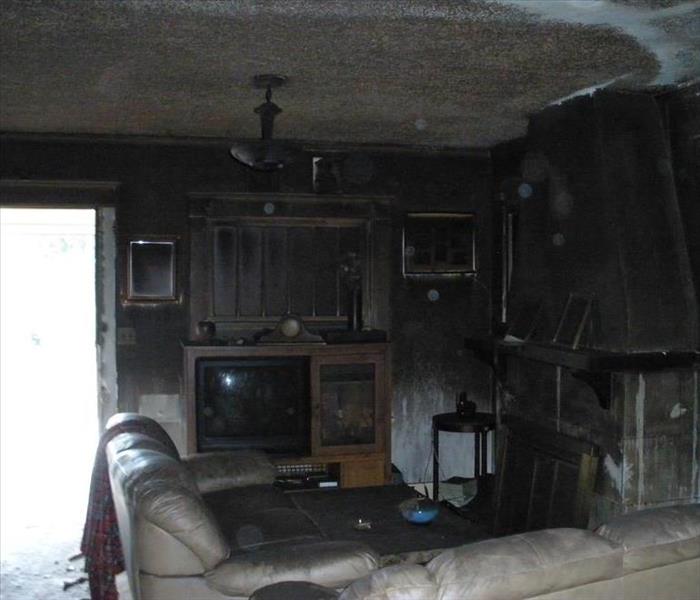 fire damaged living room filled with soot