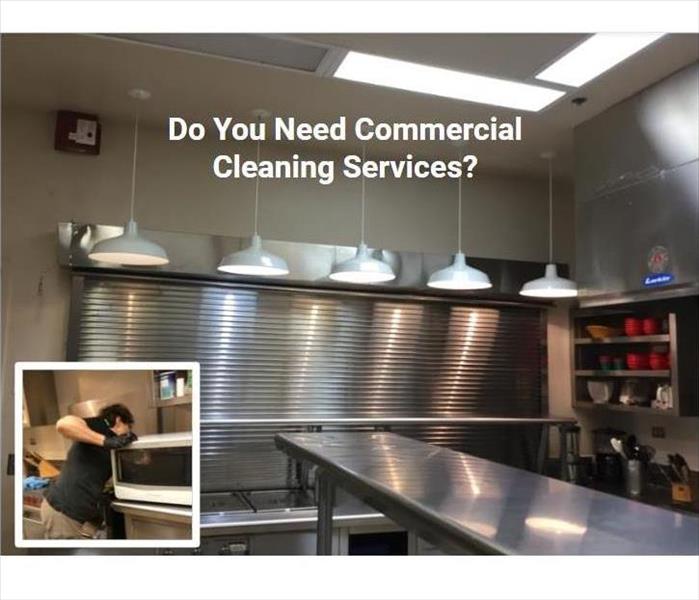clean commercial kitchen with male employee moving shelves