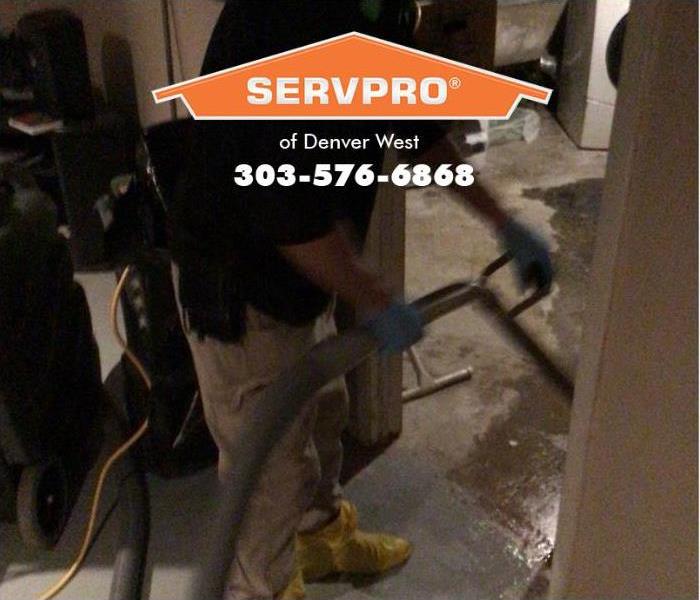  A SERVPRO of Denver West technician is extracting water from a floor.