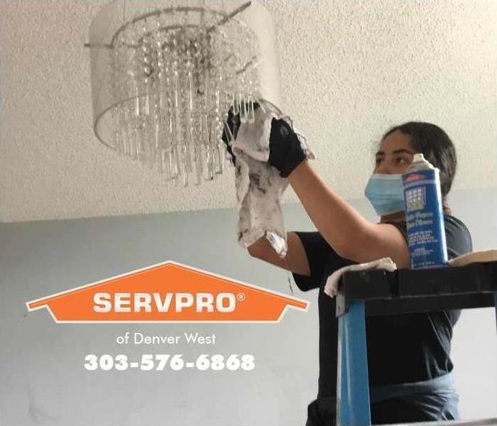 technician cleaning crystal chandelier 