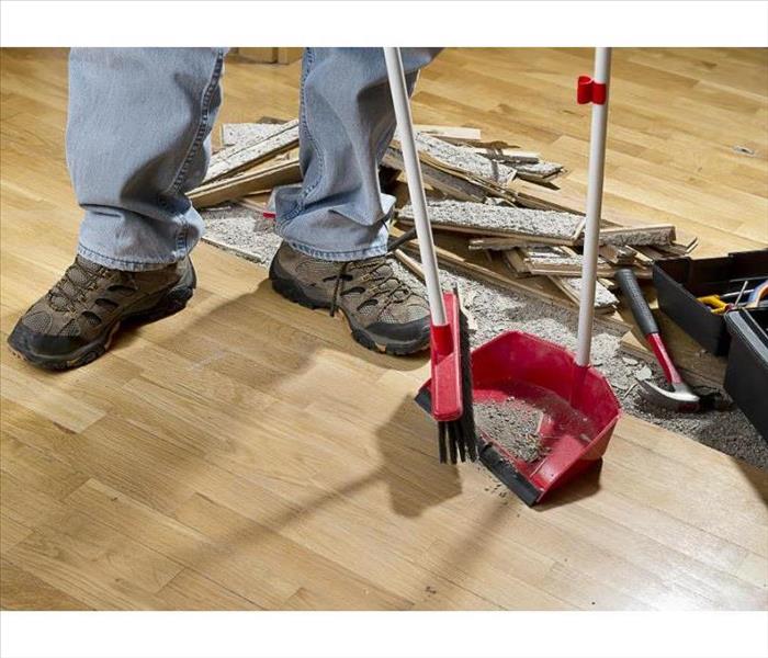Male Employee Sweeping floor debris